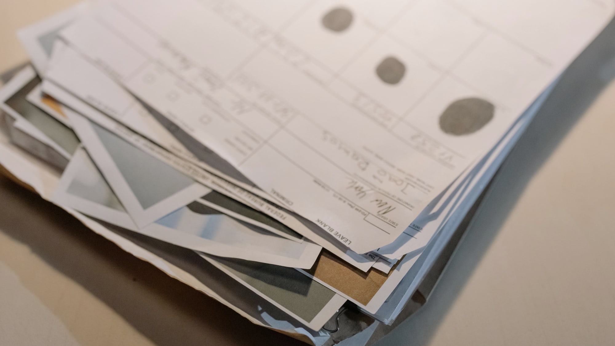 Stacked administrative papers and overlapping records on a desk