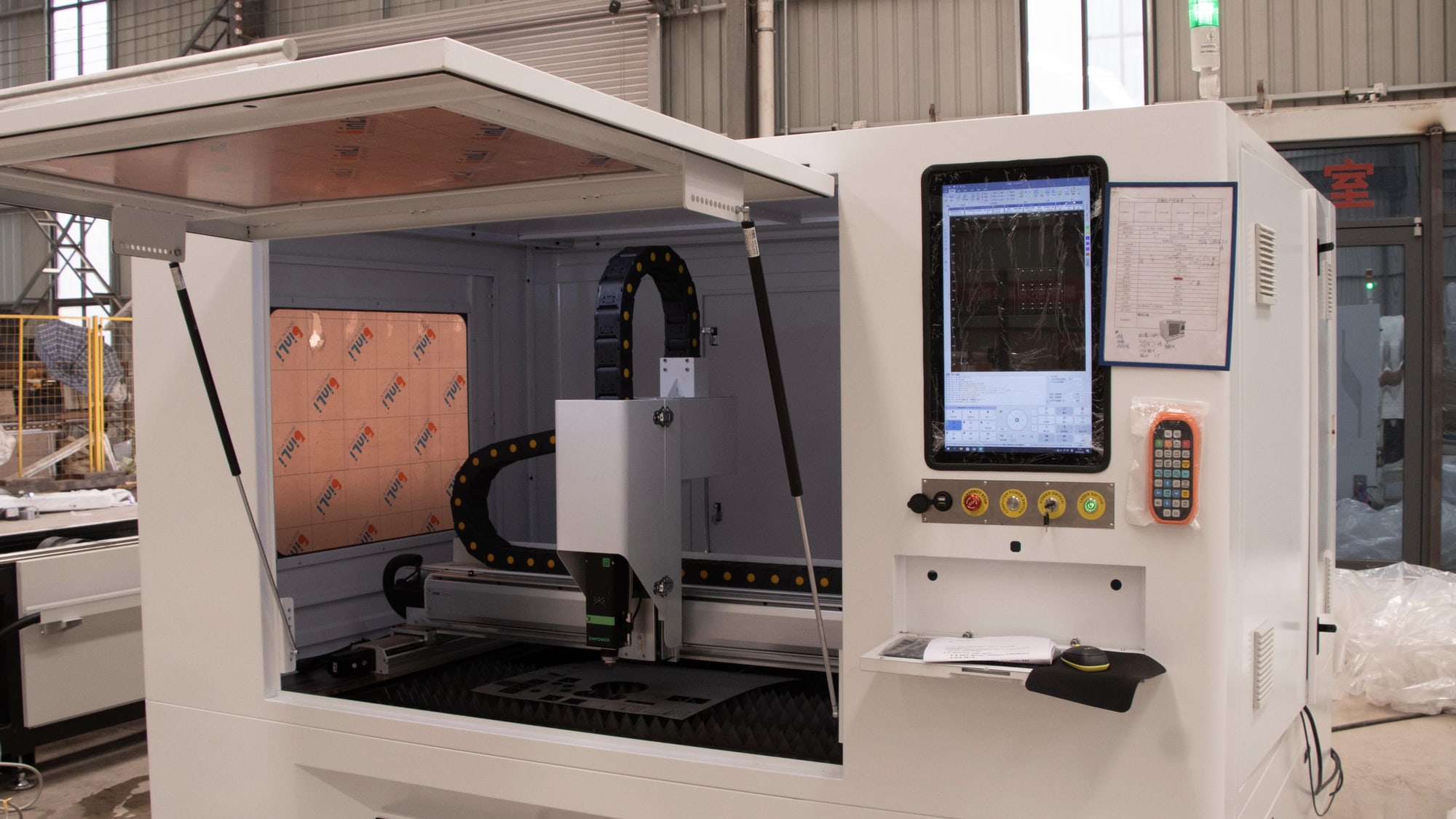 CNC machine with spindle, tooling and control panel in an industrial workshop